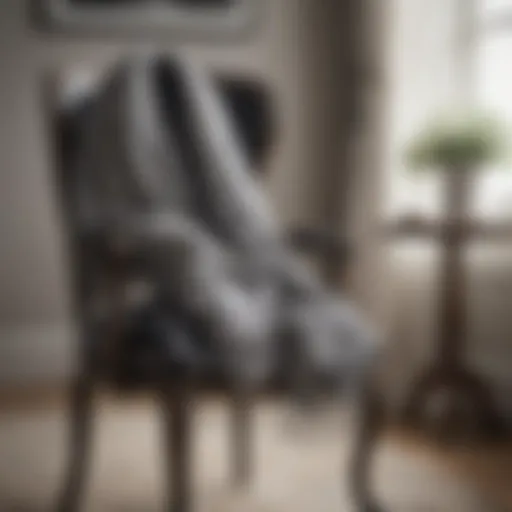 A stylish black and white checkered scarf draped elegantly over a vintage chair, highlighting its texture.